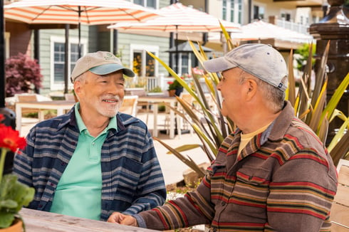 men smiling and talking outside